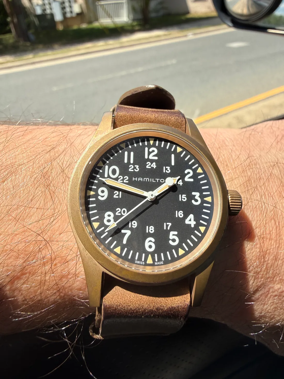 The same watch nearly four years on, the case darkened to a deep brown from daily wear.